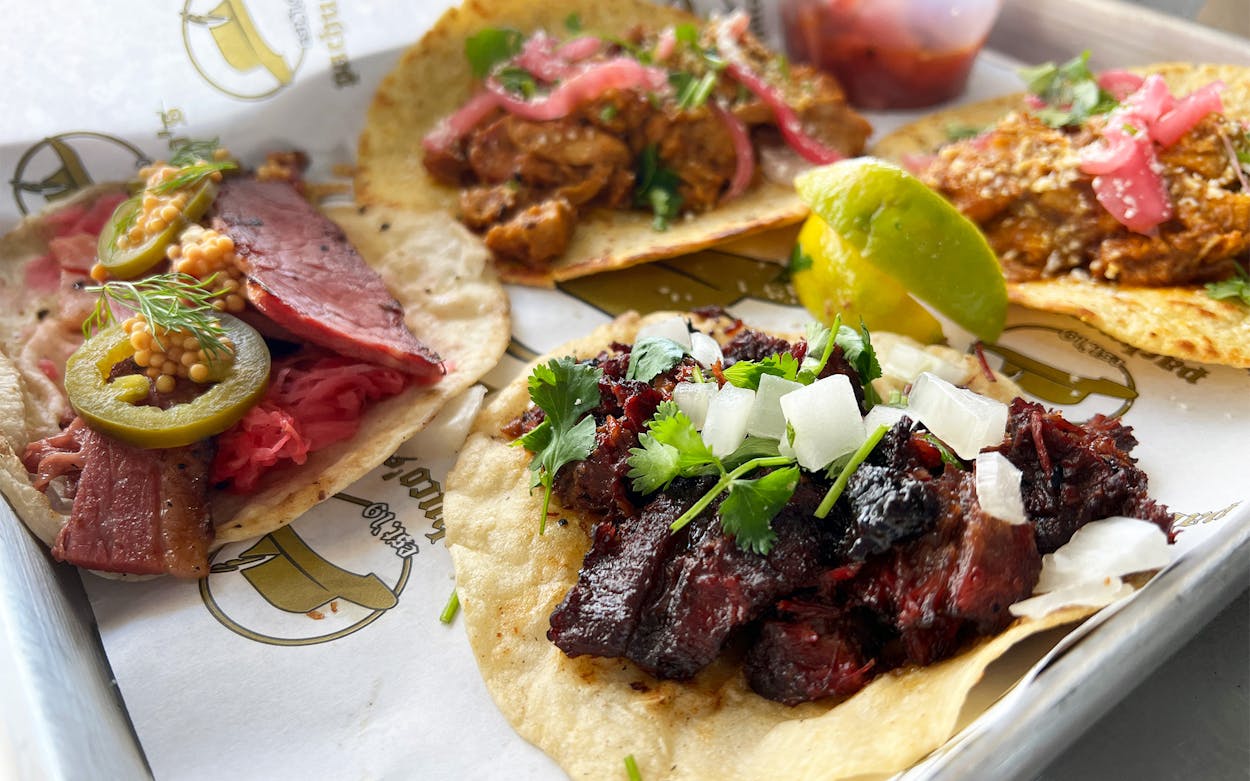 The pastrami, butter chicken, and smoked barbacoa tacos at Pachuco's.