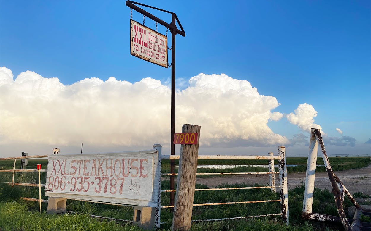 The XXL Ranch and Steak House sign between Dumas and Stinnet.
