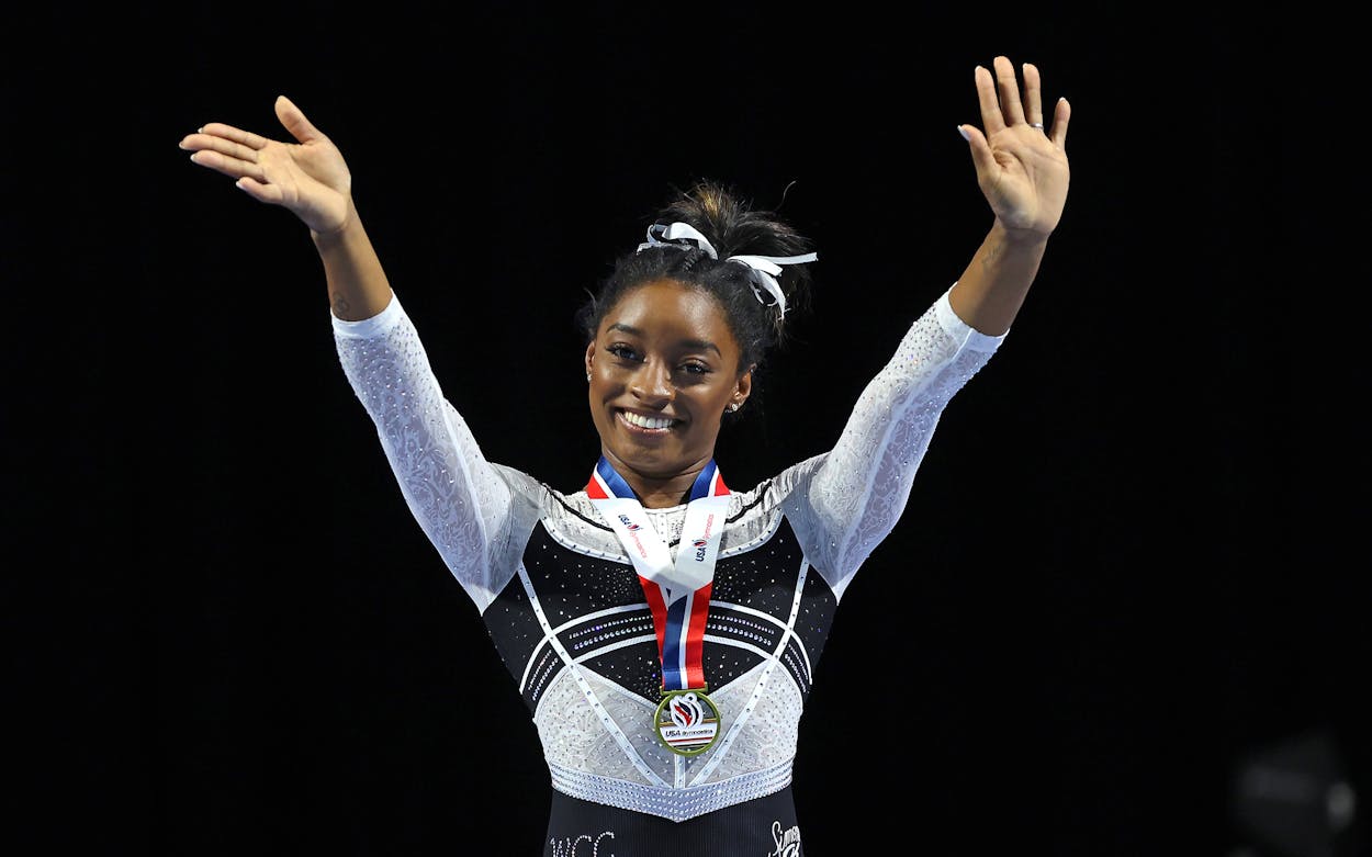 Simone Biles celebrates after winning the all-around at the Core Hydration Classic at Now Arena on August 05, 2023 in Hoffman Estates, Illinois.