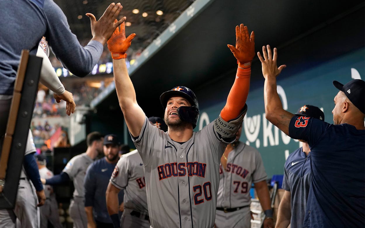Houston Astros' Chas McCormick (20) celebrates with the team after hitting a solo home run in the ninth inning of a baseball game against the Texas Rangers, Wednesday, Sept. 6, 2023, in Arlington, Texas.