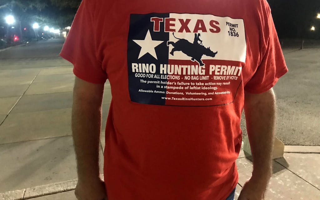 In pre-dawn hours, a line started to form outside the Capitol grounds. A group arrived from North Texas wearing red pro-Paxton shirts.