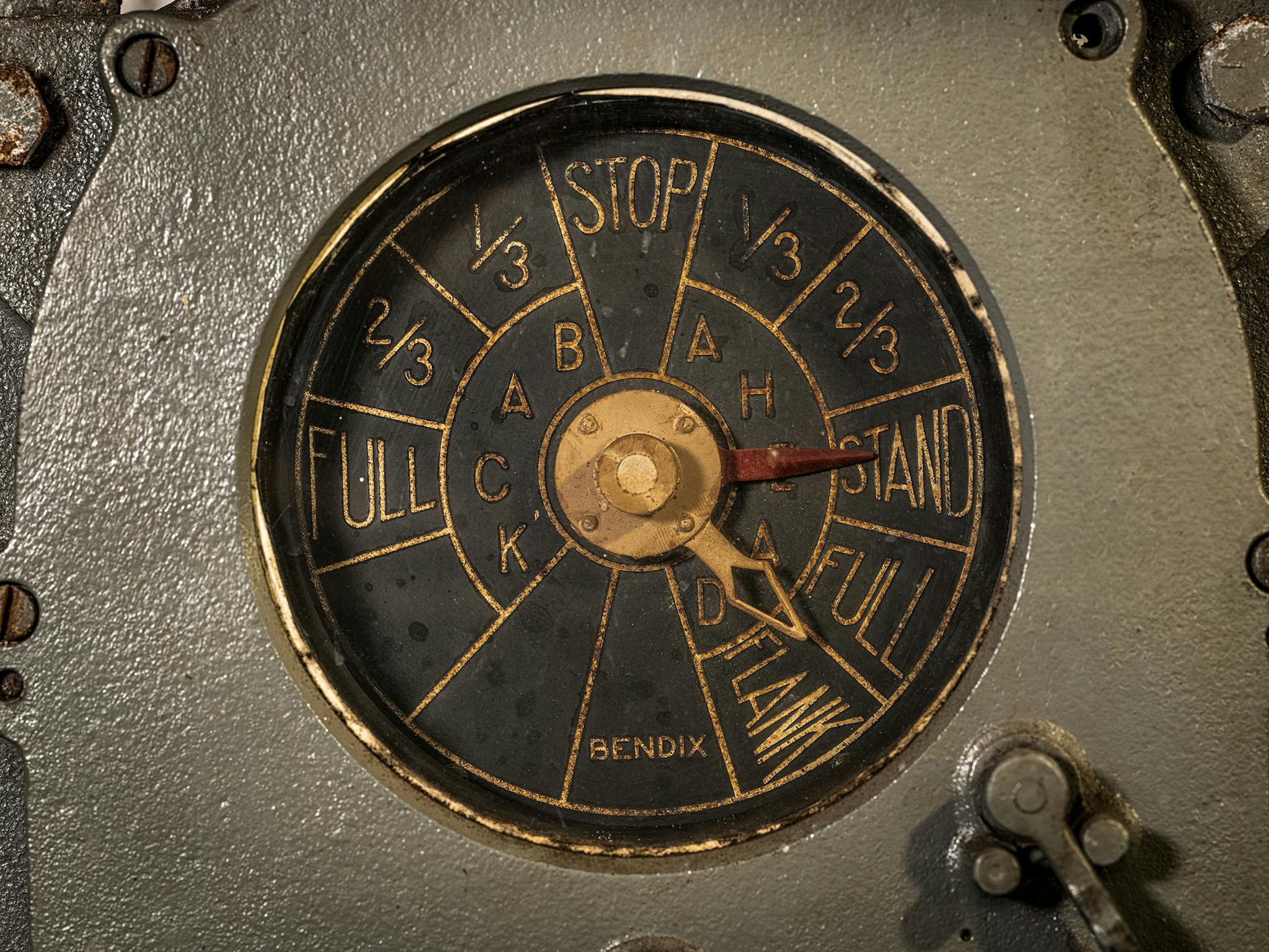 In the engine room, the red needle on the engine-order telegraph showed orders coming from the bridge. The engineer would align the white needle on the same spot, then adjust engine speed accordingly.