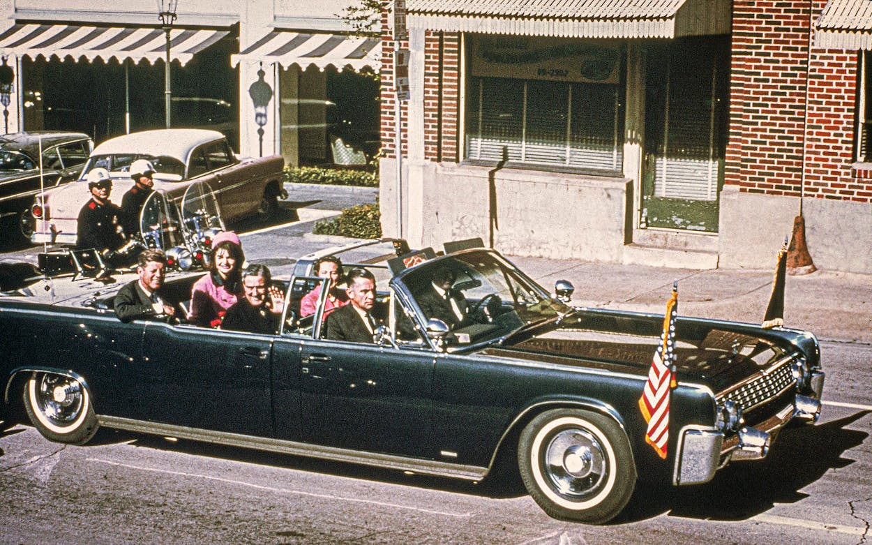 President John F. Kennedy, First Lady Jacqueline Kennedy, Texas Governor John Connally and his wife Nellie Connally ride in a limousine in Dallas on November 22, 1963 shortly before Kennedy's assassination.