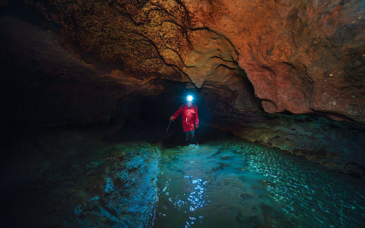 Bill Steele exploring Spring Creek Cave, near Boerne.
