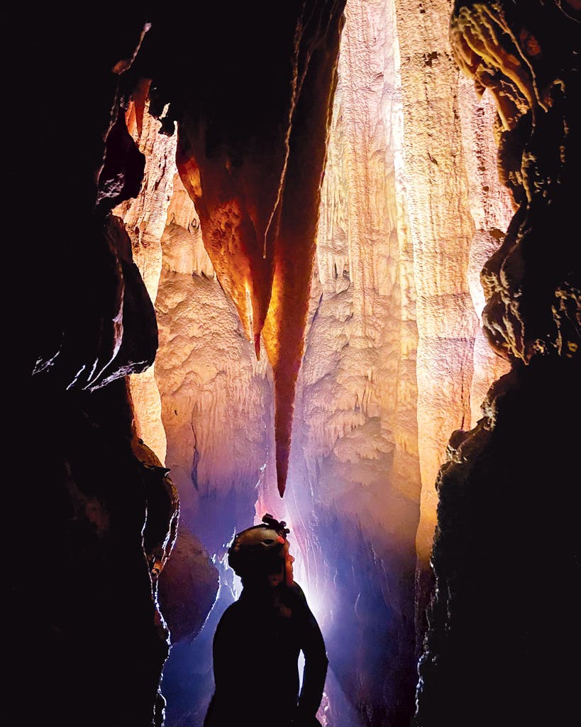 A UT Grotto caver directs his light deep inside Honey Creek Cave.