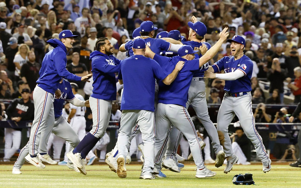 Texas Rangers players celebrate after defeating the Arizona Diamondbacks in Game 5 of the MLB World Series, clinching their first title, at Chase Field in Phoenix, Arizona, on Nov. 1, 2023.
