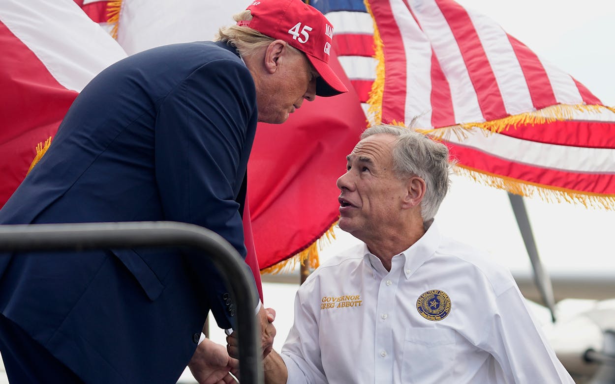 Trump shakes hands with Texas Gov. Greg Abbott, right, after he received Abbott's endorsement at the South Texas International Airport Sunday, Nov. 19, 2023, in Edinburg, Texas.