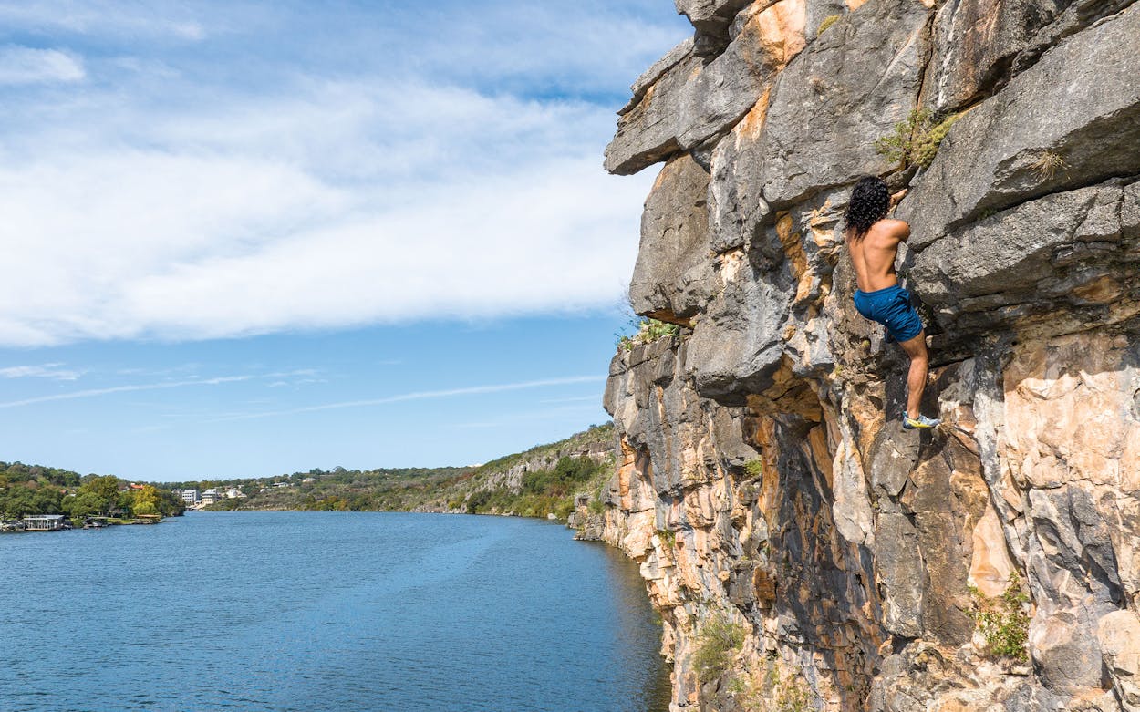 Caleb Dandridge scaling the cliffs at Lake Marble Falls.