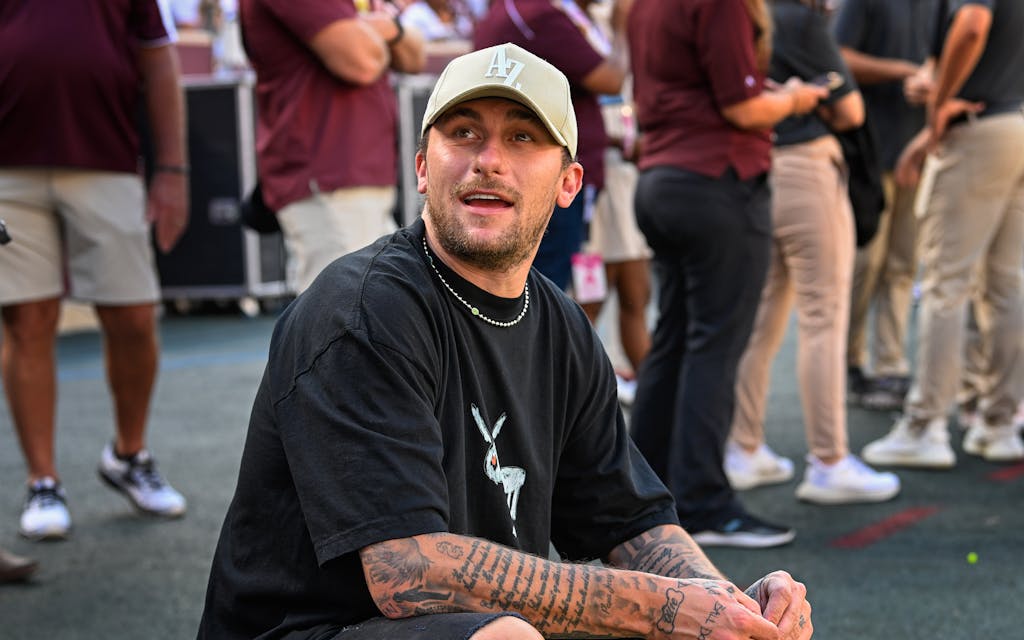 Former Aggie quarterback and Heisman Trophy winner Johnny Manziel watches from the Aggie sideline during the football game between the Louisiana Monroe Warhawks and Texas A&M Aggies at Kyle Field on September 16, 2023 in College Station, Texas.