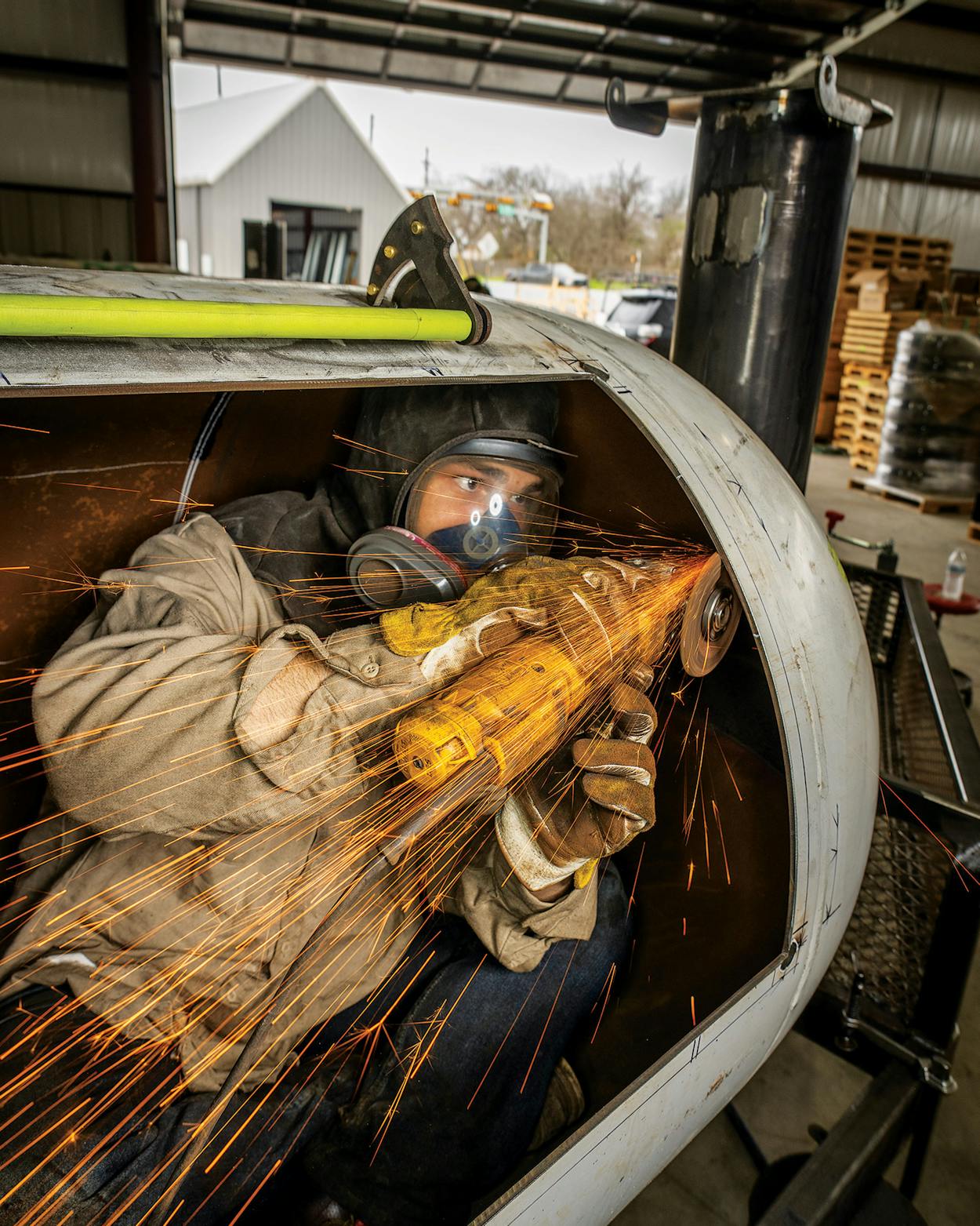 Welder Ricky Castillo working on the inside of a custom smoker at Mill Scale Metalworks, in Lockhart, on February 16, 2024.