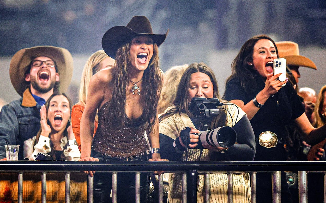 Fashion model Bella Hadid (center) reacts during The American Performance Horseman on March 08, 2024 in Arlington.