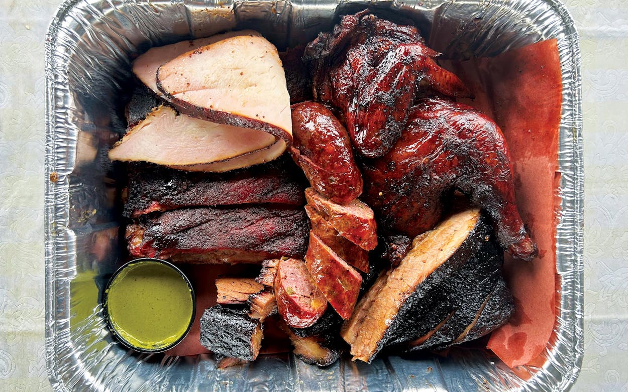 A plate featuring the different meats at LA23 BBQ.