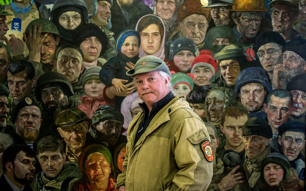 Russell "Texas" Bentley in front of the painting "Donbass" dating from 2016 by Russian painter Aleksandr Novosyolov at the Donetsk Art Museum on Wednesday, April 12, 2017 in Donetsk, Ukraine.