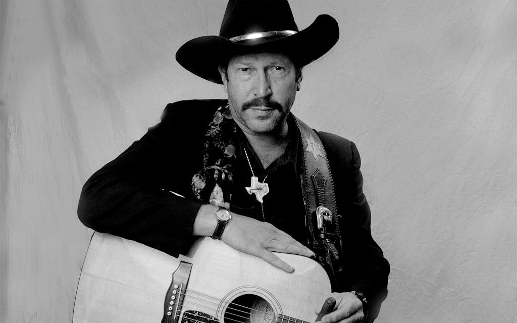 Portrait of American musician, author, and comedian Kinky Friedman as he poses backstage during the Farm Aid benefit concert at Texas Stadium, Dallas, Texas, March 14, 1992.
