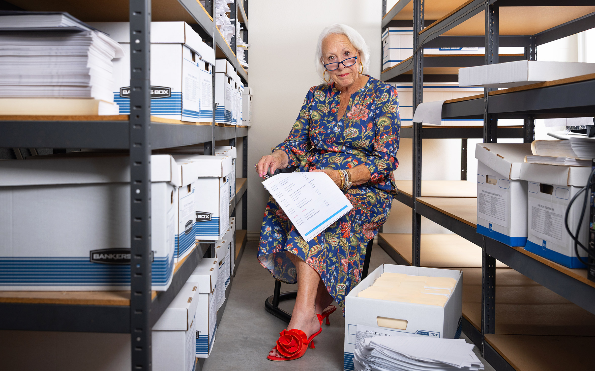 photo of woman surrounded by bankers boxes